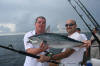 Captain Trent holding fresh catch.